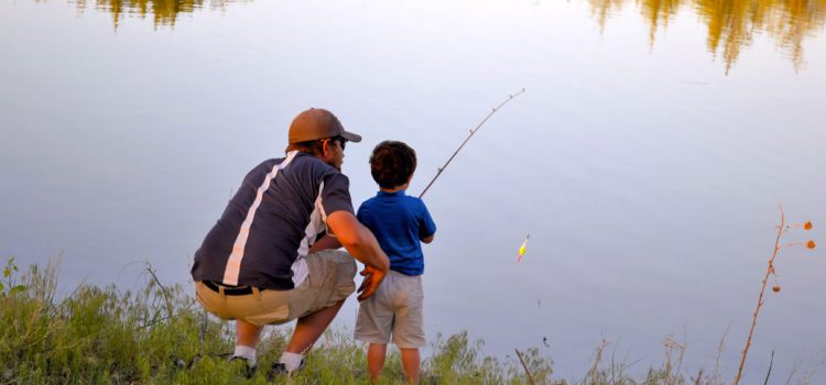 dad and son fishing in lake