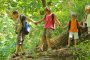 kids holding hands on hiking trail